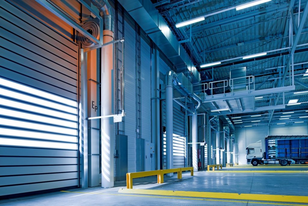 A spacious warehouse in Surrey with abundant doors, in need of professional warehouse cleaning services.